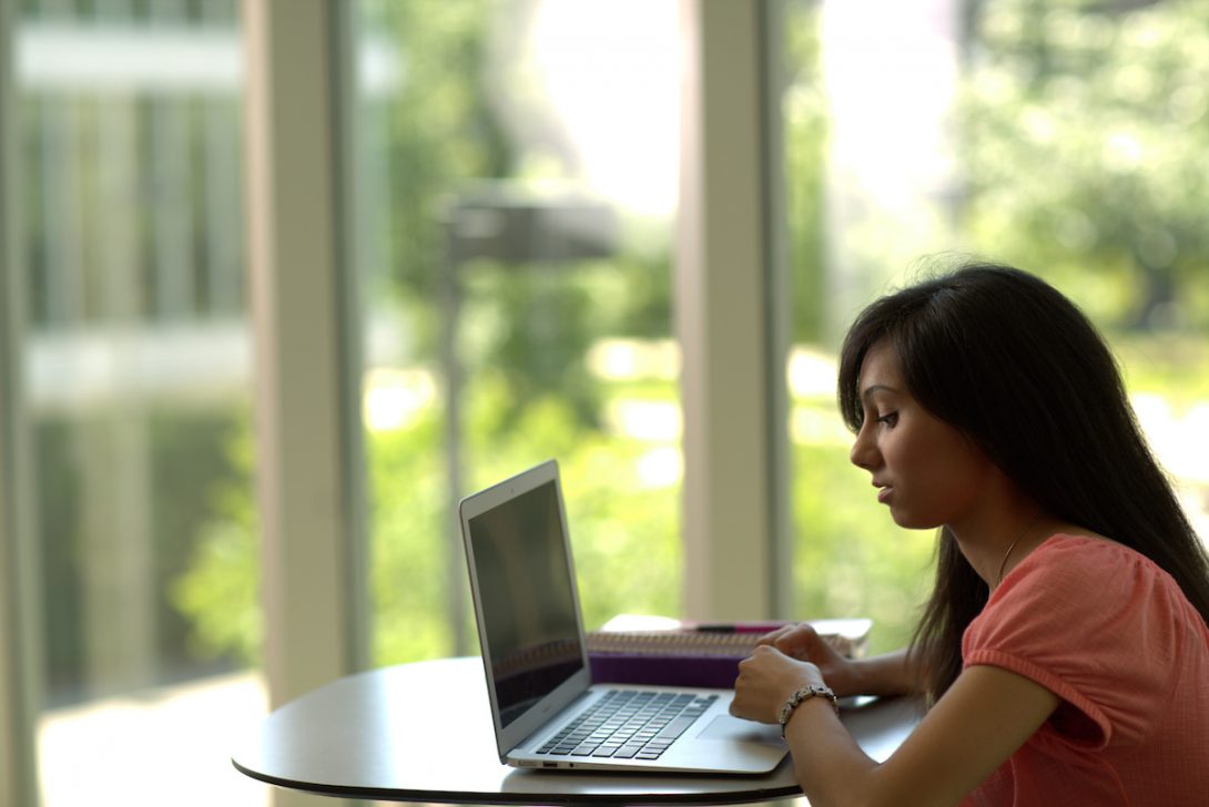 student looking at a laptop screen