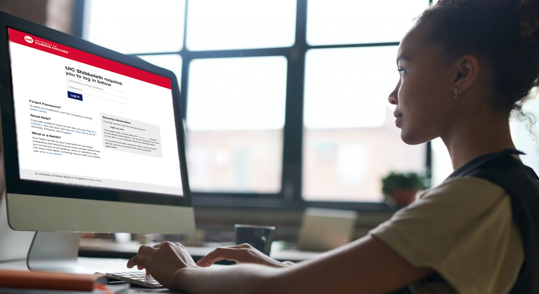 student on computer with updated UIC login page on screen