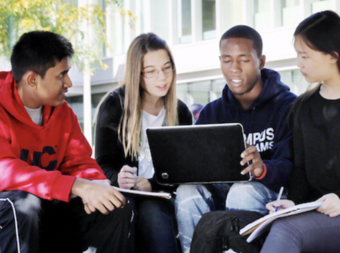 students using wifi on a laptop outside