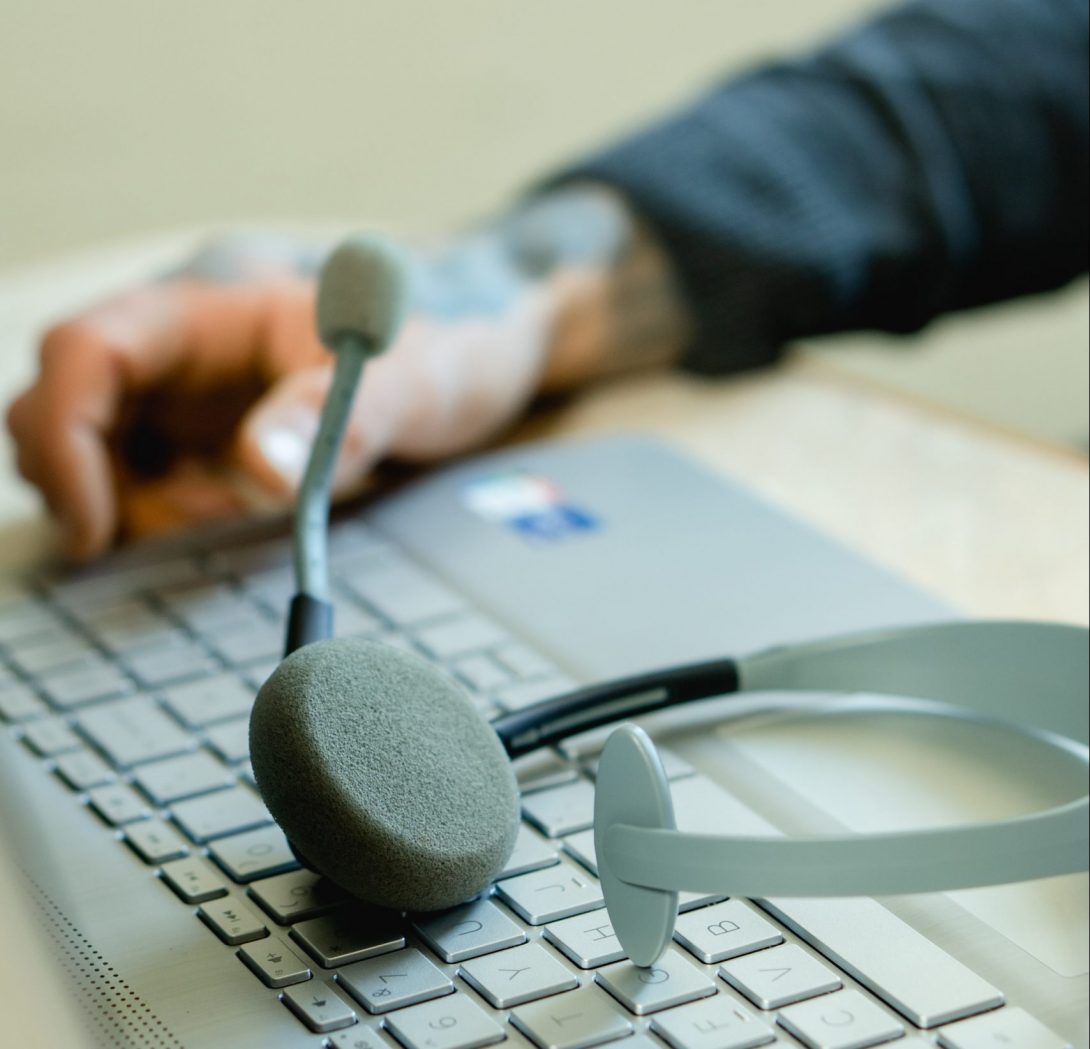 closeup of a hand and headset on a keyboard