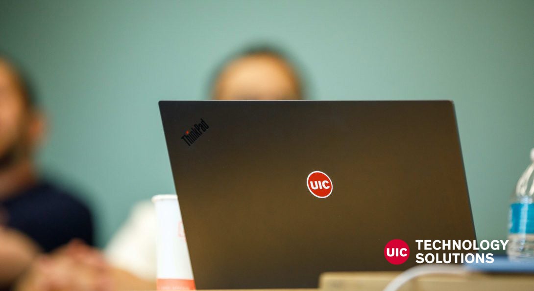 Close-up of laptop with UIC logo