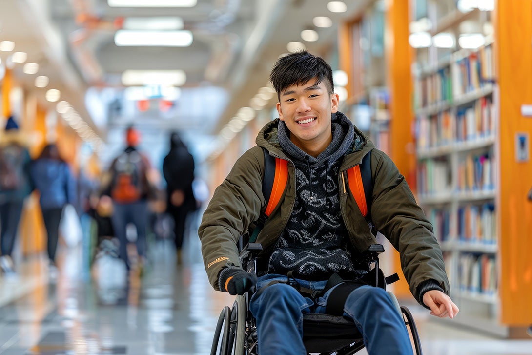 student in wheelchair at campus library