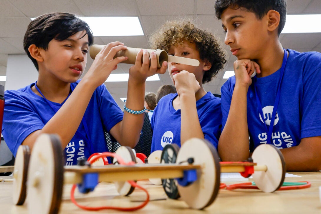 Camp students interacting with a engineering task