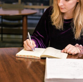 student making notes
                  