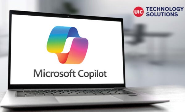 Microsoft Copilot logo on laptop screen and Technology Solutions logo for decoration only