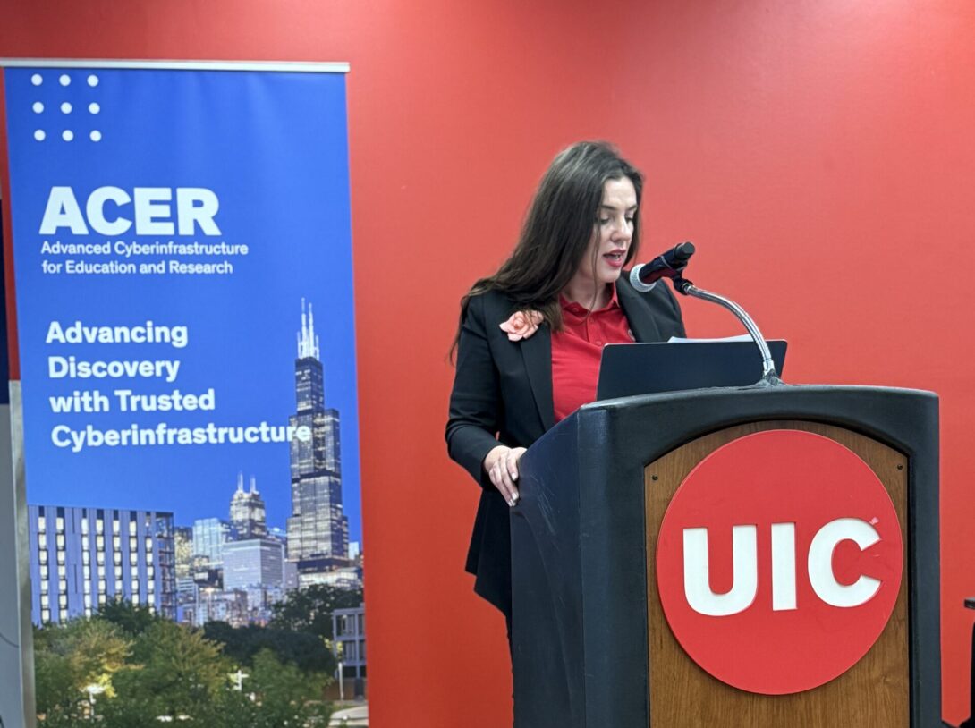 A 2025 Computational Research Symposium participant speaks at the podium.