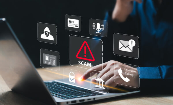 A hand clicking on the keyboard of a laptop and icons of phishing email scams
